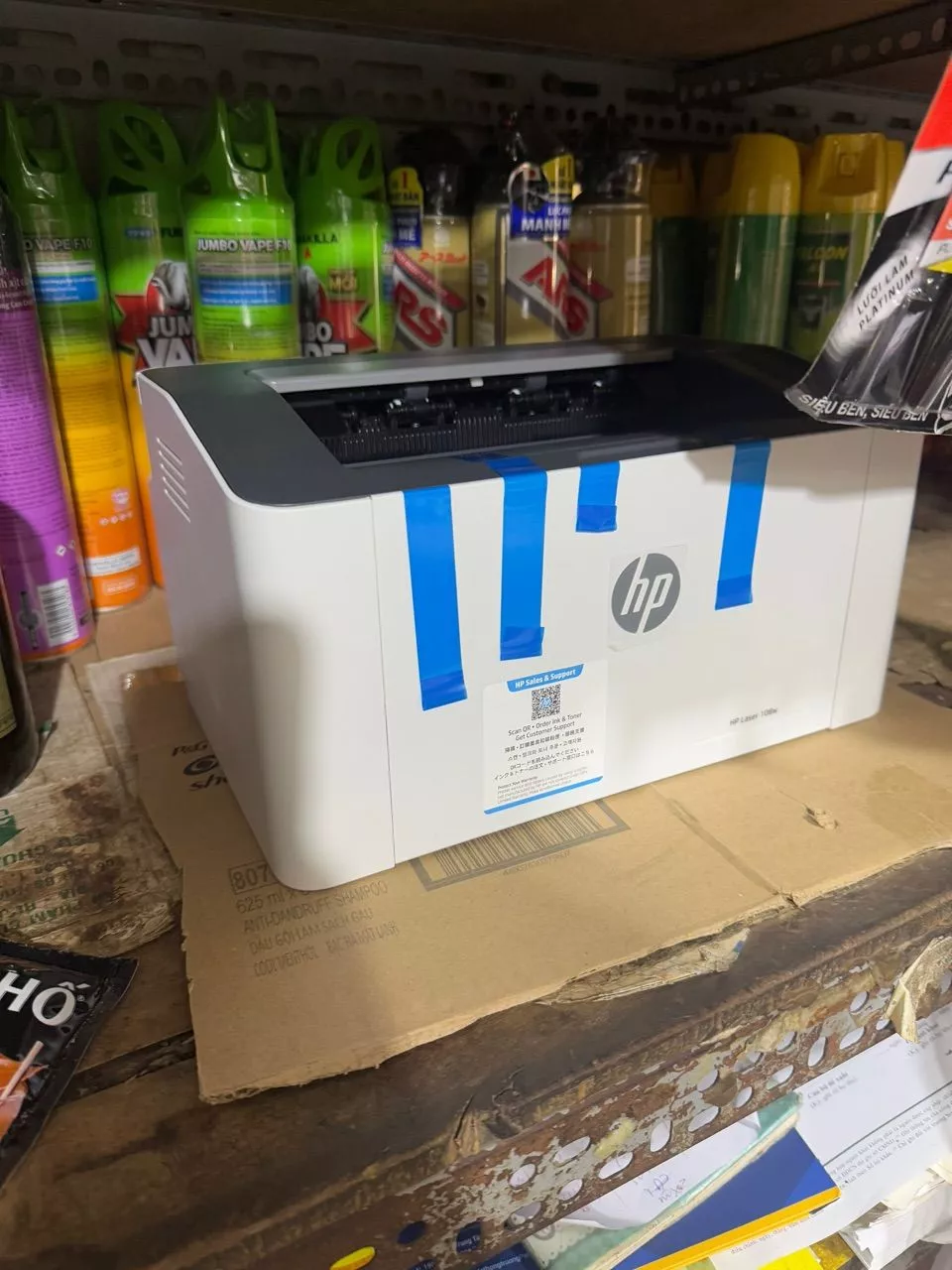Ảnh khách chụp máy HP Laser 108w vừa mở hộp, còn băng dán bảo vệ màu xanh